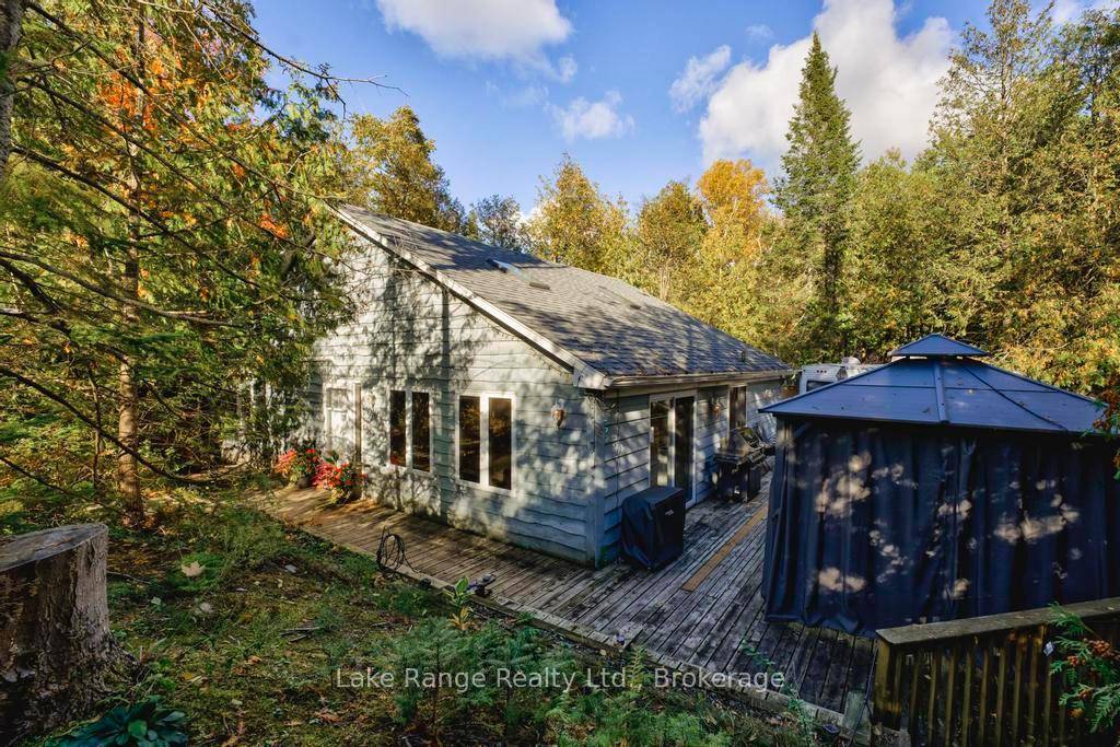 Discover your year round retreat nestled among mature trees, offering both beauty and privacy.