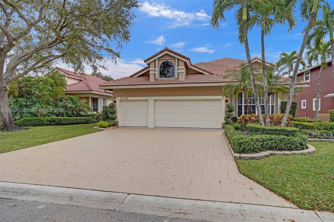 Welcome to your dream waterfront home in the prestigious gated community of Eagle Trace in Coral Springs.