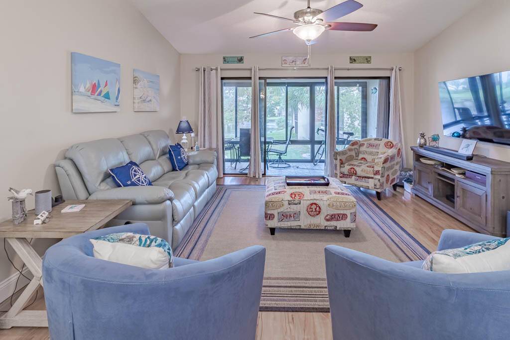 LOCATED IN THE HEART OF STUART This beautifully updated second floor condo has impact glass, vaulted ceilings, sparkling lake views, and covered parking.