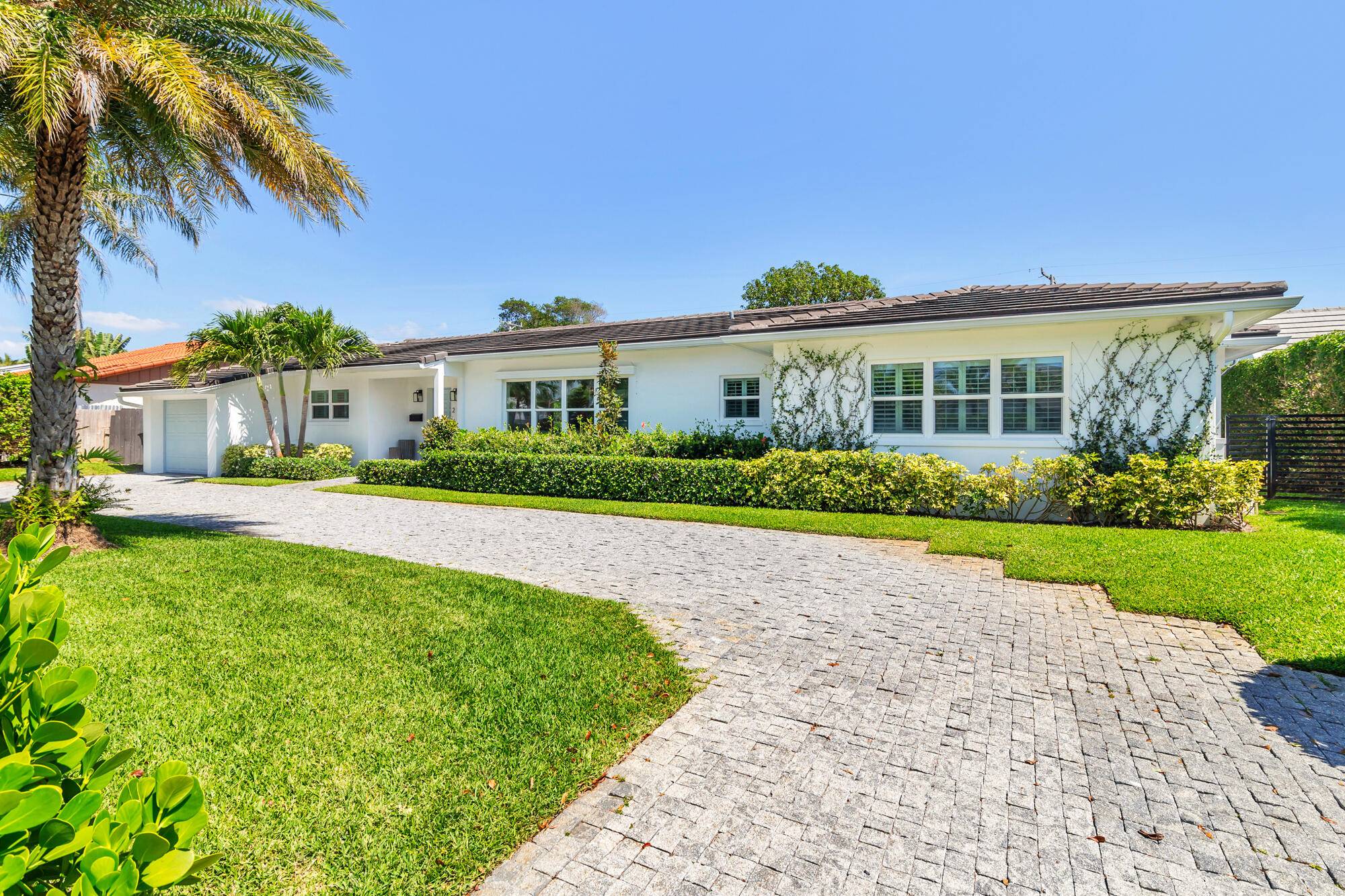 Nestled in the sought after SoSo neighborhood of West Palm Beach, this 3 bedroom 3 bathroom home, renovated by Caroline Rafferty Interiors, offers a spacious layout.