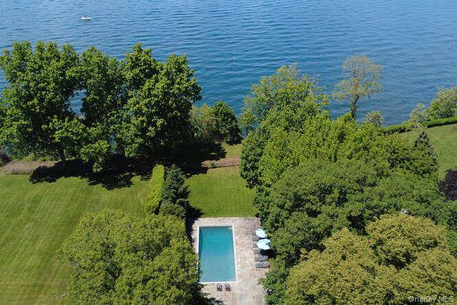 Welcome to 7 Cedar Ln, a remarkable turn key residence perched high above the water on the Gold Coast.