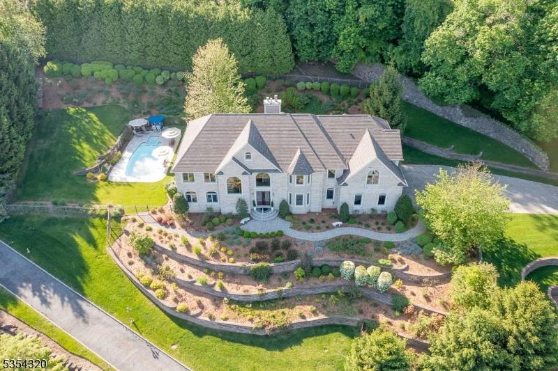 Unparalleled privacy spectacular NYC views coexist in this newer, meticulously maintained brick stucco 6400 sf custom center hall Colonial.