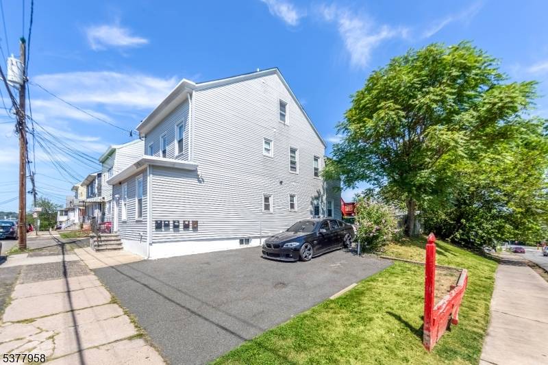 Welcome to 93 95 Dixon Ave where home ownership meets income potential in this spacious 3 family home in Paterson.