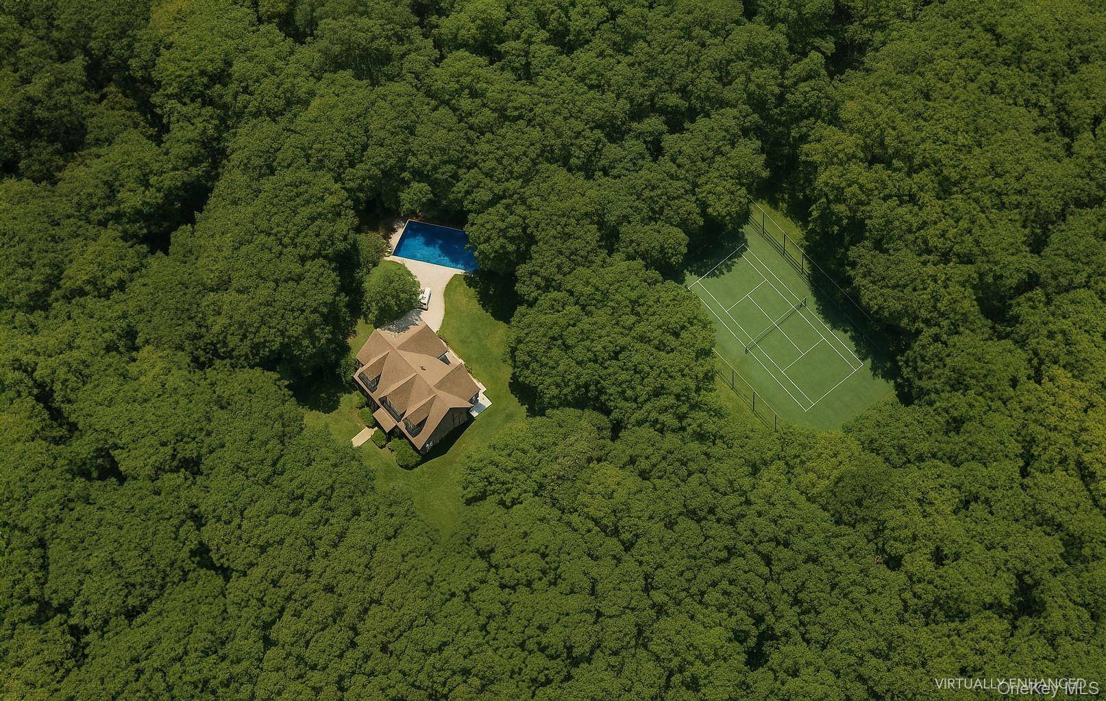 A truly rare offering in East Hampton's coveted Northwest Woods, this gracious gabled traditional sits on 5.