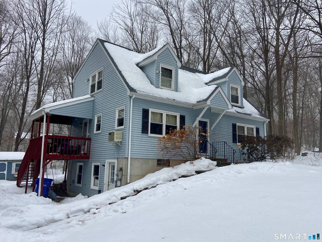 1990 built full dormered vinyl sided cape nicely placed on.