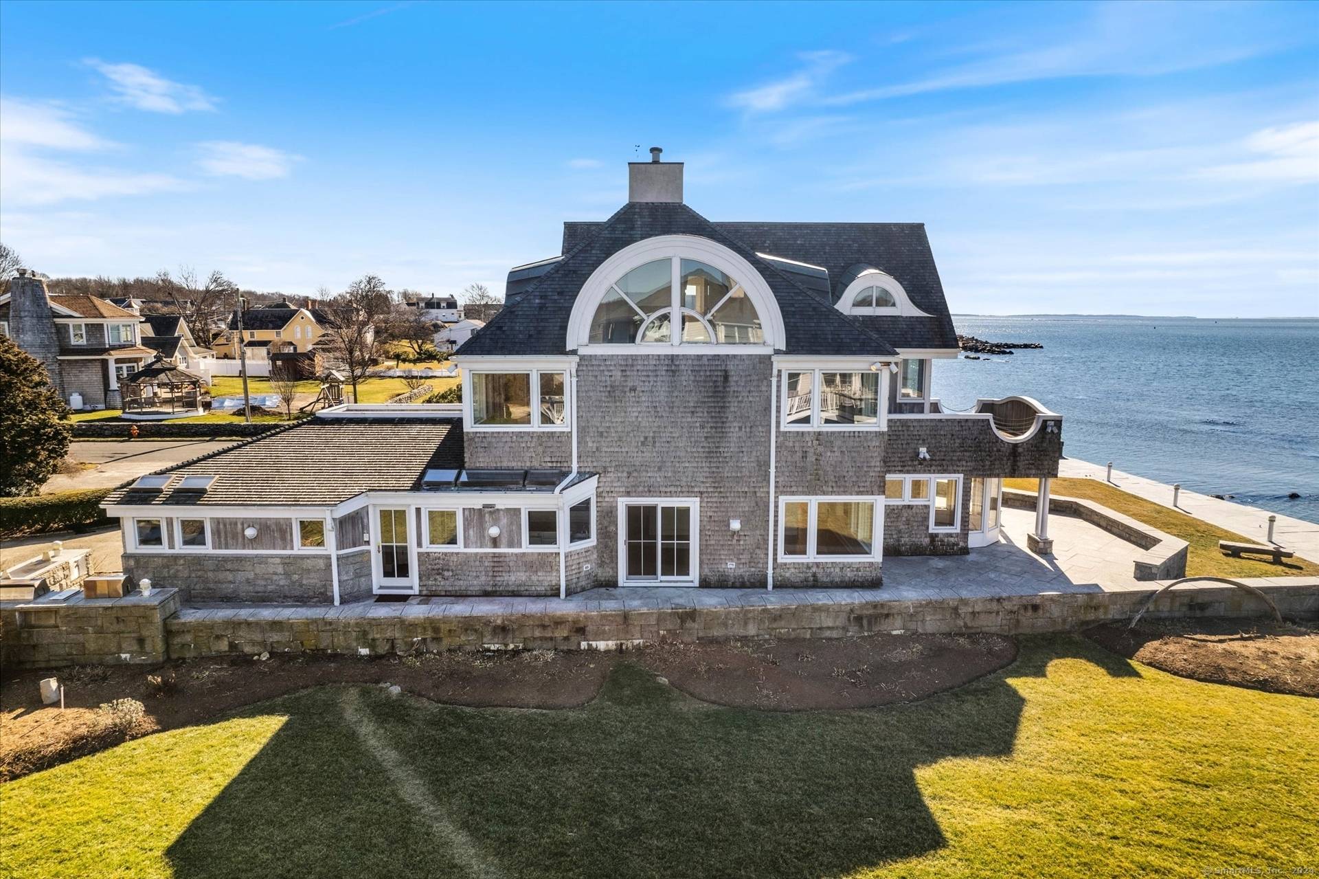 Unwind while lounging in front of Connecticut's most stunning sunsets from this waterfront property with timeless views of L.