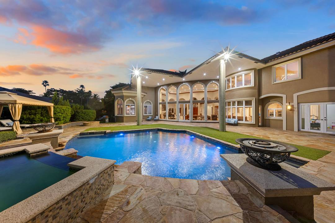 Masterfully designed, this exclusive Boca Grove estate rests on over half an acre, and captures tranquil, sweeping views of the golf course.