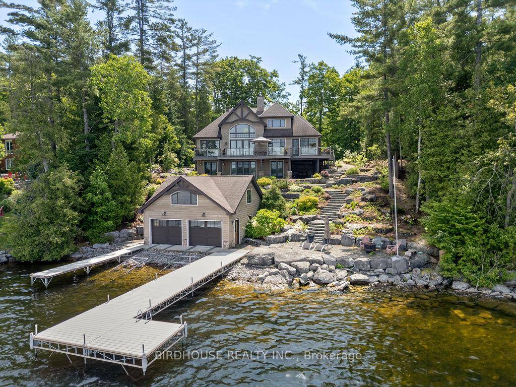 Welcome to this exceptional bungaloft waterfront home offering 103 feet of crystal clear deep shoreline on prestigious Clear Lake, and just a short boat ride to Stoney Lake.
