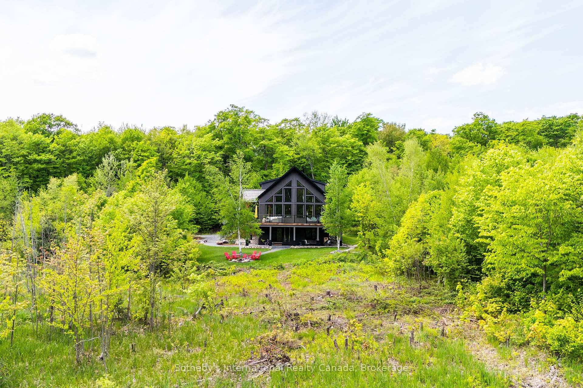 Nestled in Muskoka Lakes, this stunning property spans approximately 20 acres of lush, forested land, complete with an incredible lookout over a serene pond.