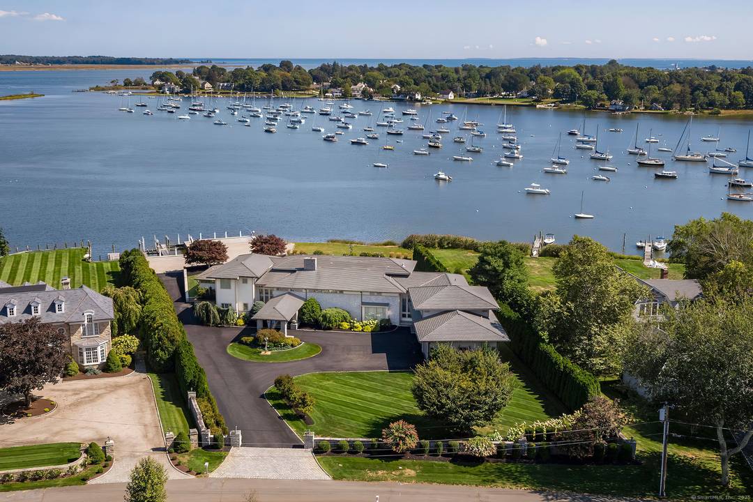 An EXTRAORDINARY MODERN MASTERPIECE Inspired by renowned architect Frank Lloyd Wright, sited to take full advantage of an exceptional, private 1.