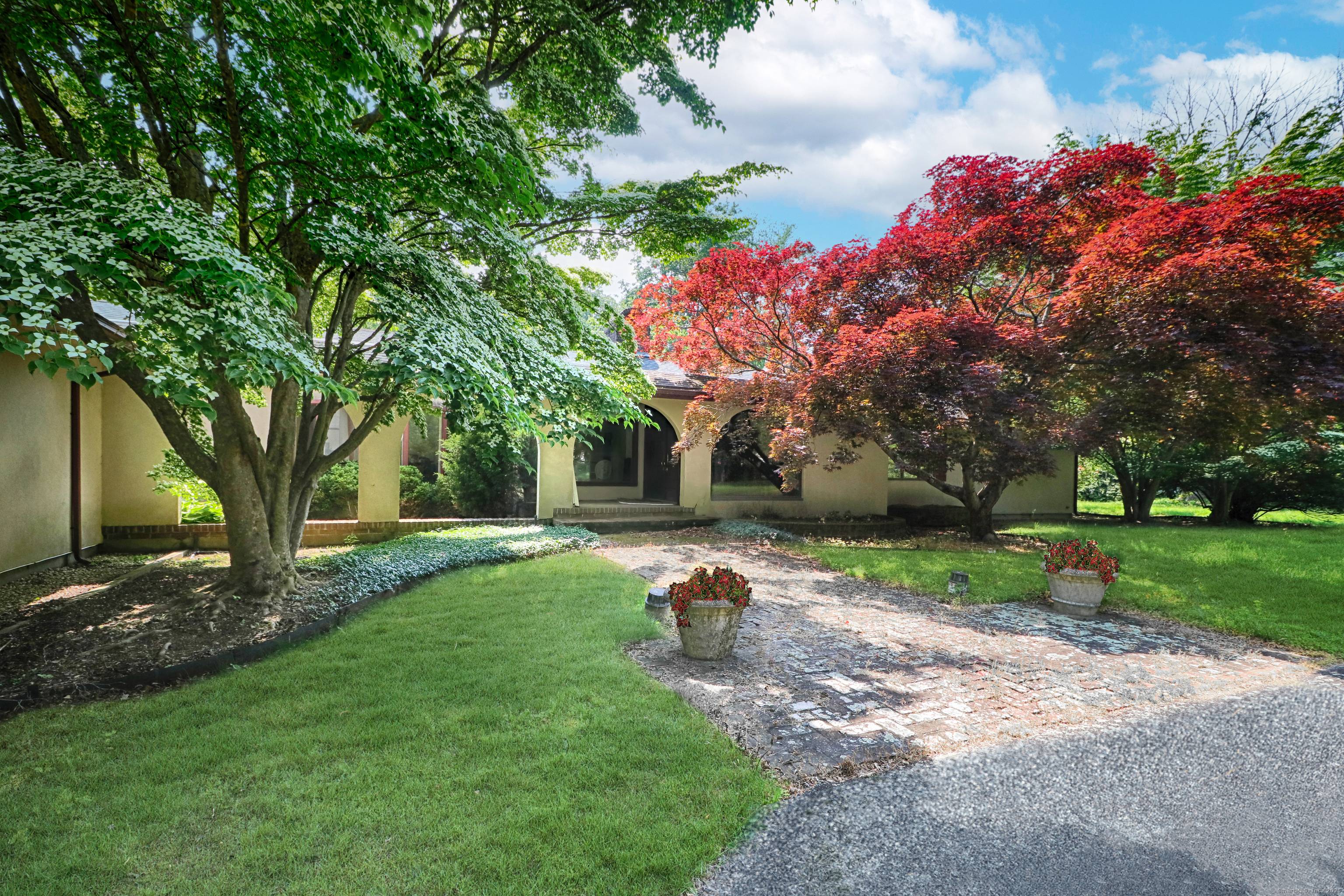 Sprawling ten room ranch style residence offering 3 acres on a prime estate street in Greenfield Hill.