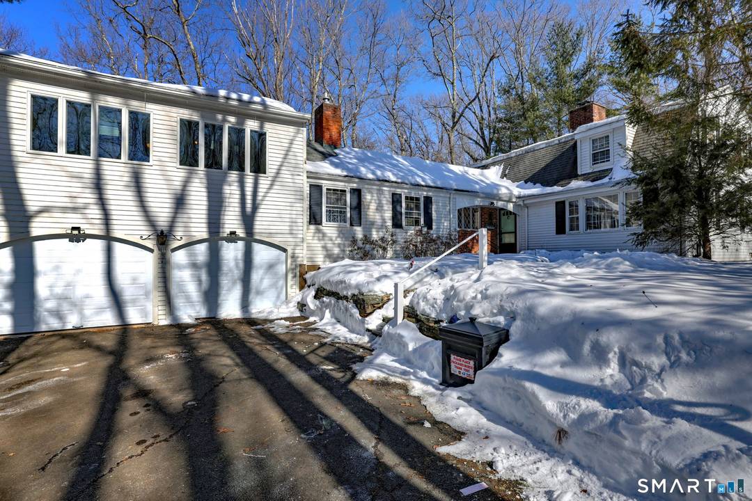 Nestled in a picture perfect setting behind a stone wall in a sought after neighborhood, this attractive 2, 900 SF Gambrel style home offers charm, privacy and convenience.