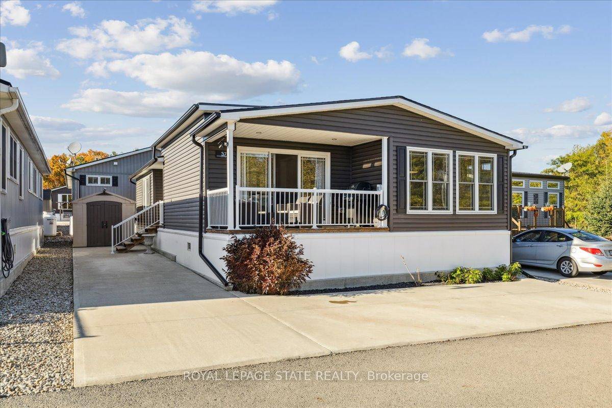 Welcome to this exceptional modular home, perfectly situated on leased land within the exclusive gated community of Lost Forest in north Burlington.