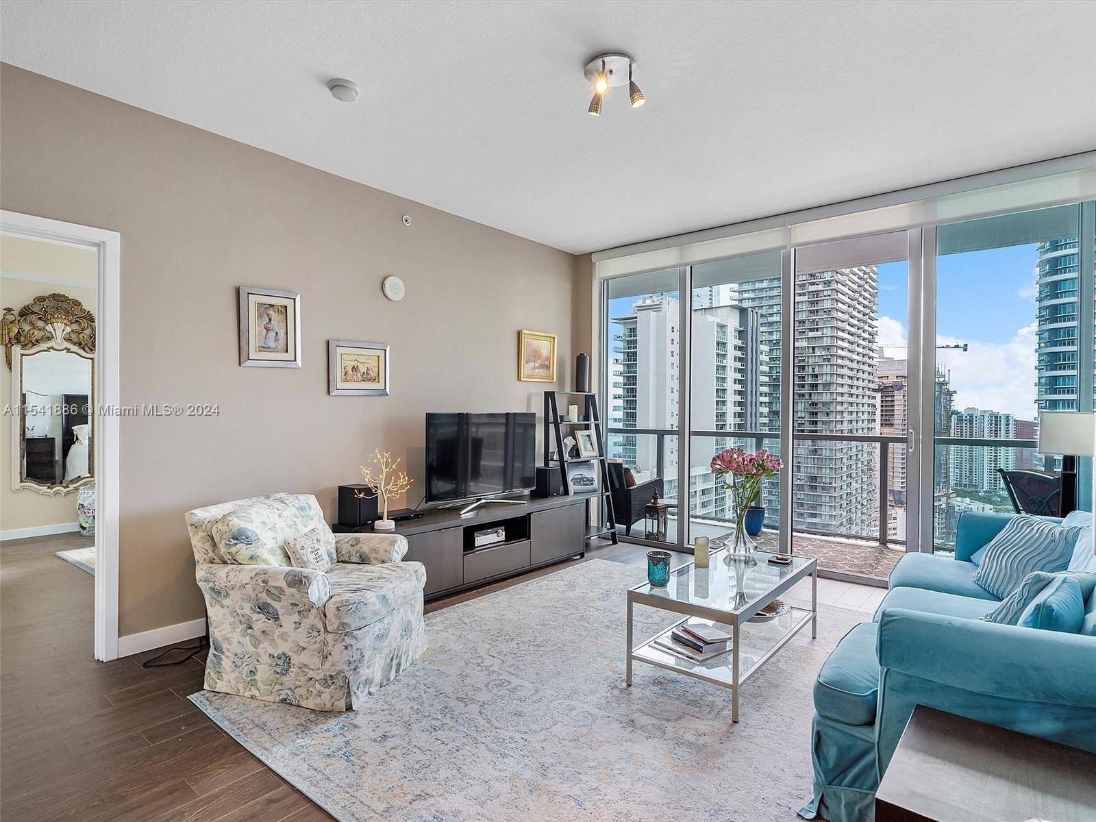 Indulge in breathtaking water and city views from this 32nd floor luxury condo.