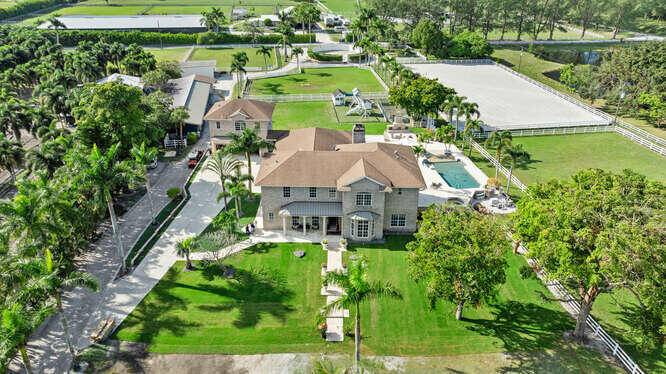 Discover luxury and privacy at this stunning 6 bedroom, 5 bathroom equestrian estate on 5 serene acres in West Boca Raton.