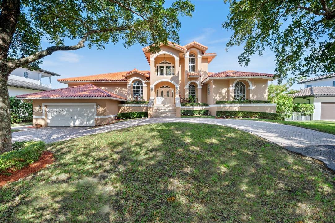 Stately and impressive executive residence set on an expansive 12, 000 SF canal front lot with a tranquil, picturesque backdrop.
