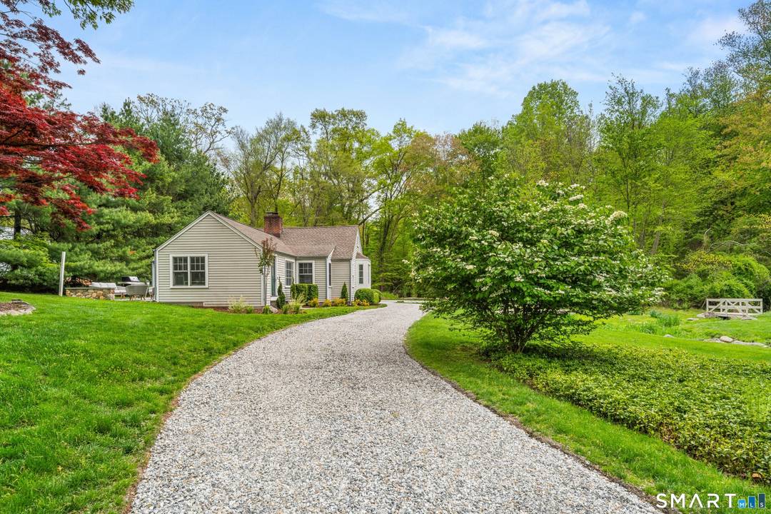 Tucked away in a storybook setting on over an acre of land, this beautifully rebuilt 3 bedroom home offers effortless one level living surrounded by nature.