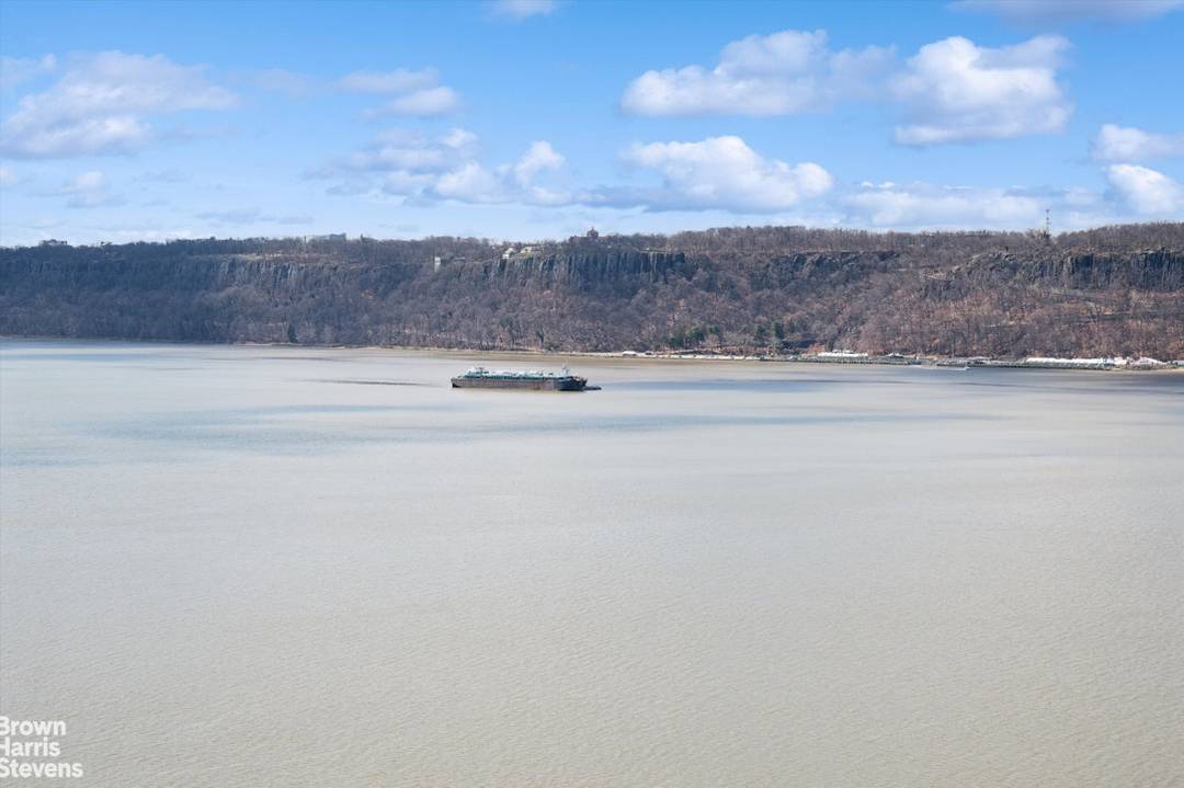 This stunning corner apartment at Hudson and Palisade Avenue offers magnificent, unobstructed views of the Hudson River and two iconic bridges.