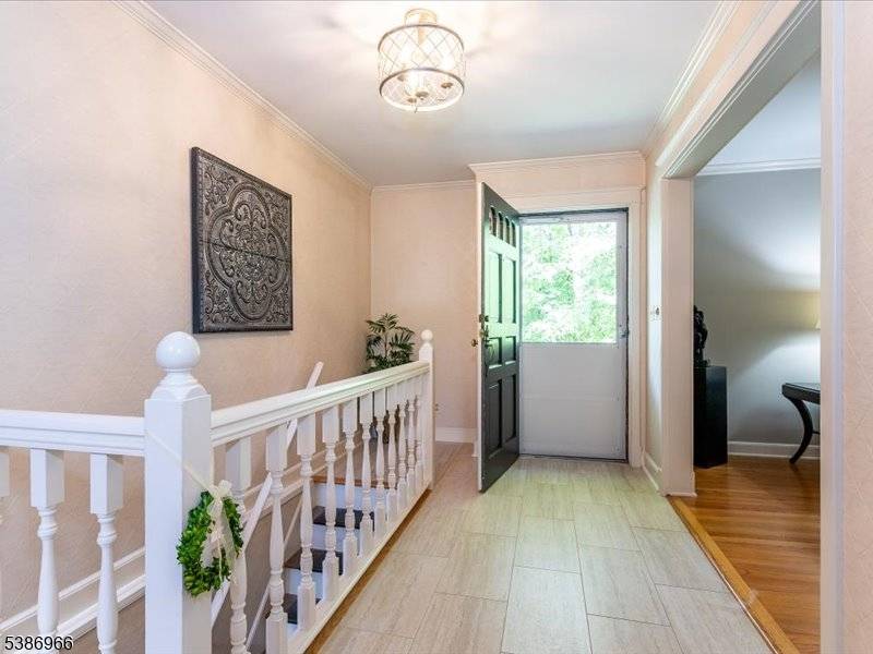 Serenely situated on over two wooded acres in a prime cul de sac location, this Expanded Ranch offers the ultimate in tranquil privacy.