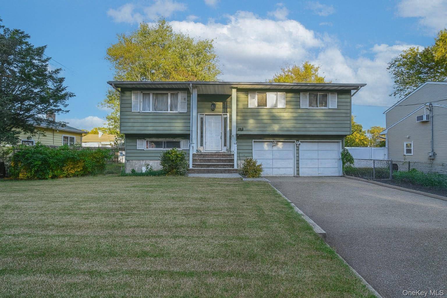 Welcome to this beautifully maintained High Ranch in a desirable Bay Shore neighborhood !