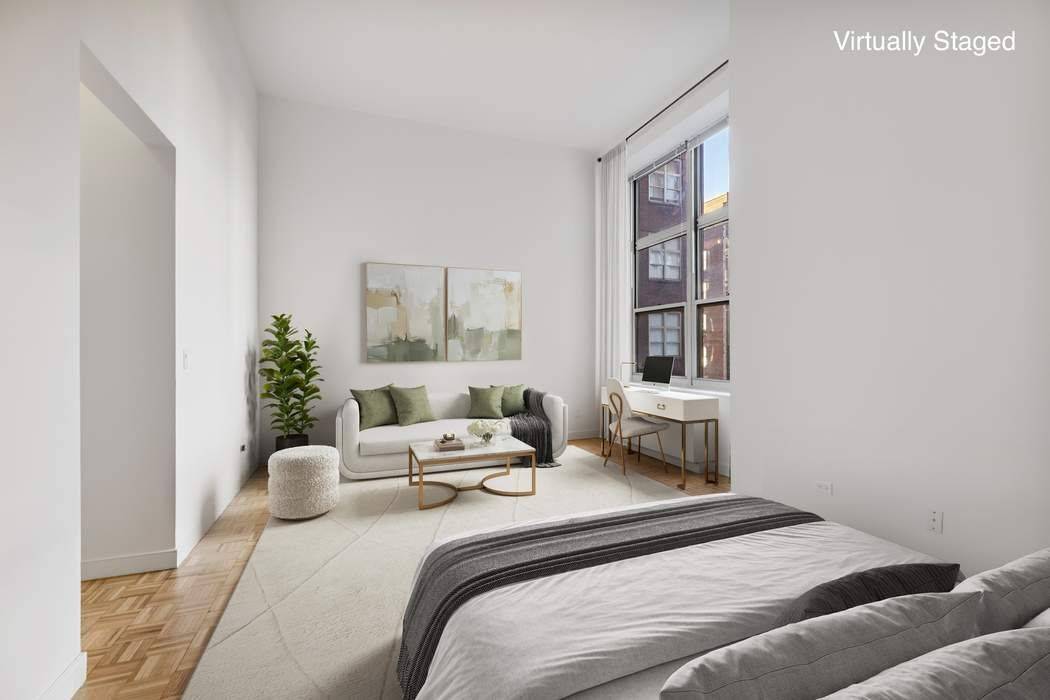 Step into this dramatic, loft like studio where soaring 13 foot ceilings and oversized windows fill the living and sleeping space with abundant natural light.