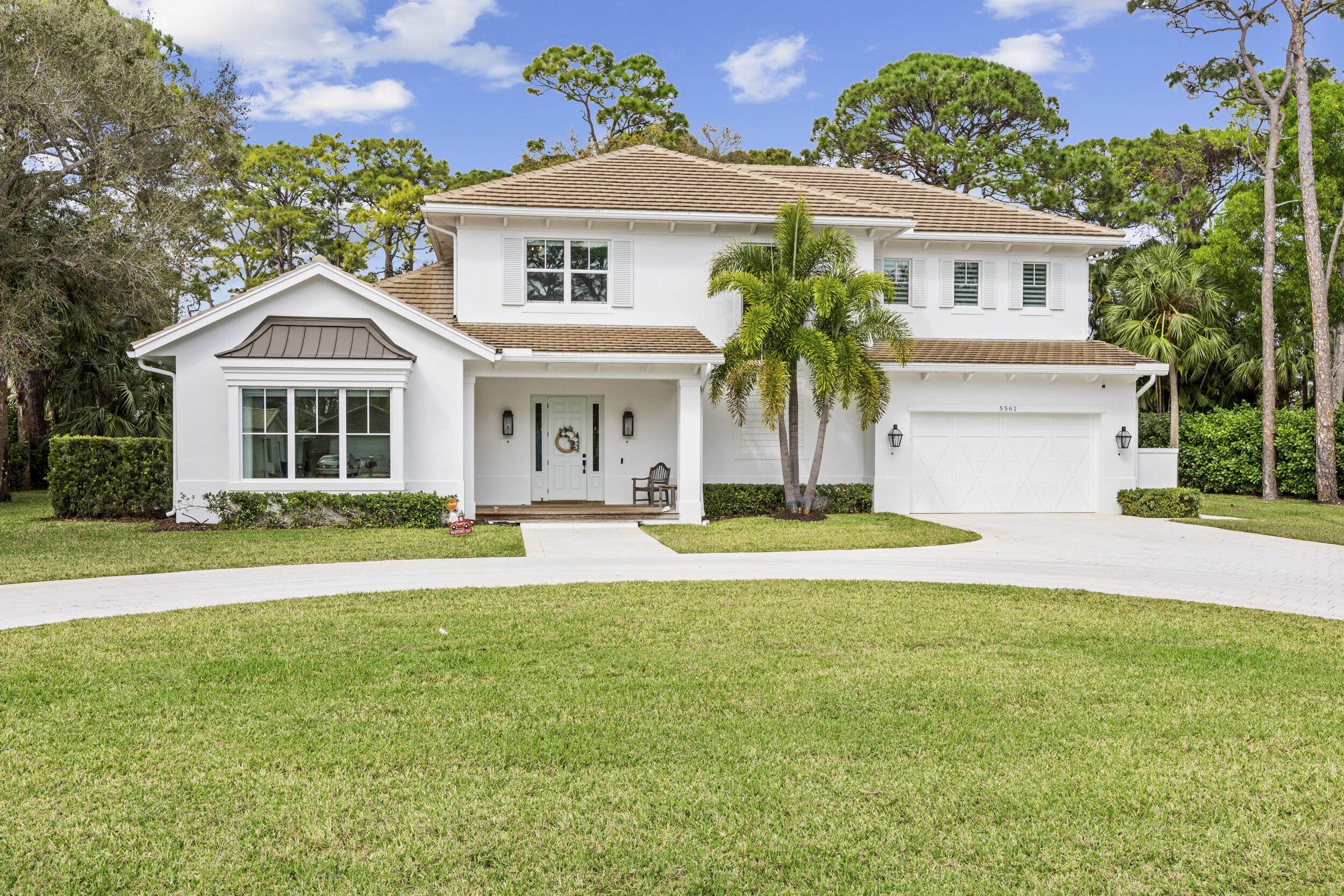 Custom coastal style family home on prestigious Pennock Point in Jupiter.