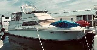 WIDE SLIP SAFELY MOORS THIS 1991 TROJAN DAY YACHT IN KEY WEST CITY MARINA IN GARRISON BIGHT.