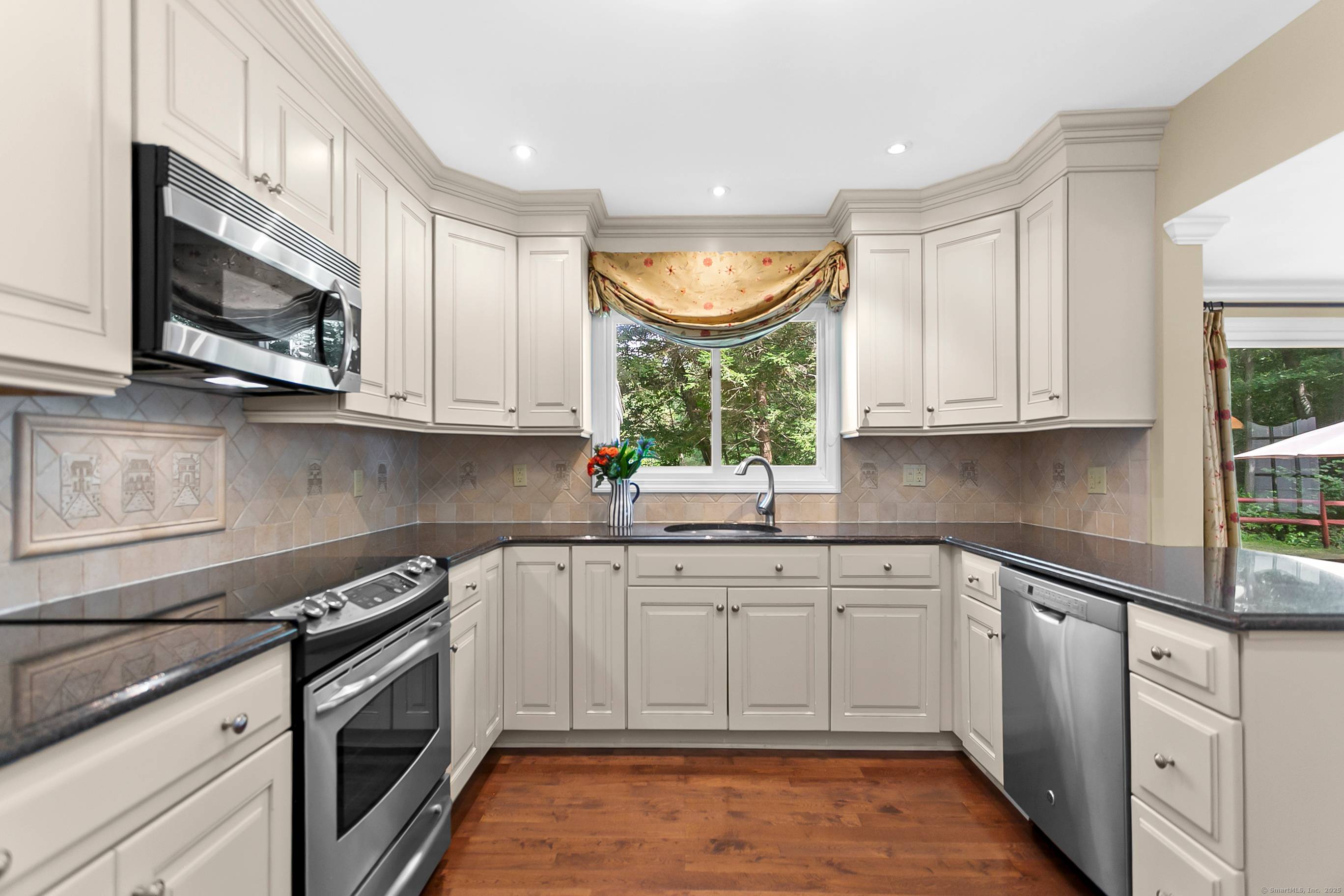 Welcome to this meticulously maintained 4 bedroom, 2 bath ranch, perfectly situated on a picturesque acre in one of North Stamford's most desirable neighborhoods.