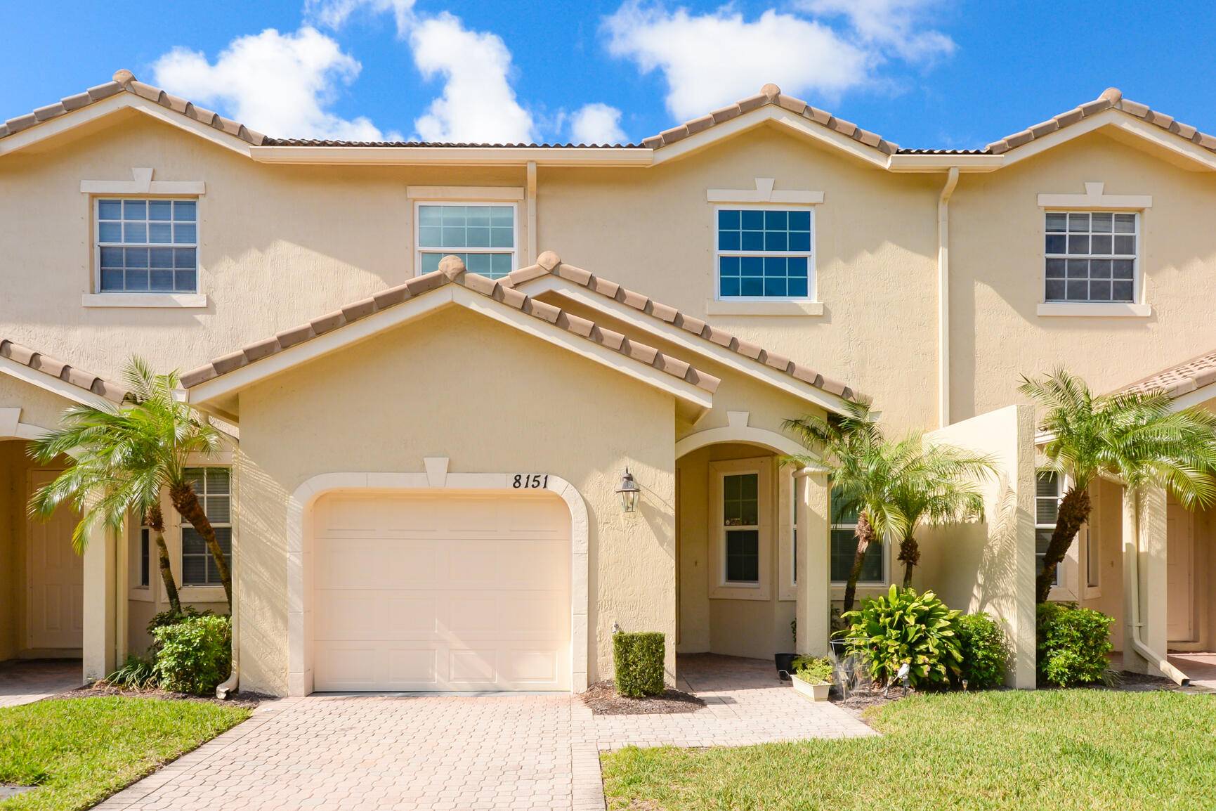 Popular ''Devon'' Model Townhouse in PGA Village with Lake View features CBS Construction, Barrel tile roof, paver driveway, 3 BR's, 2.