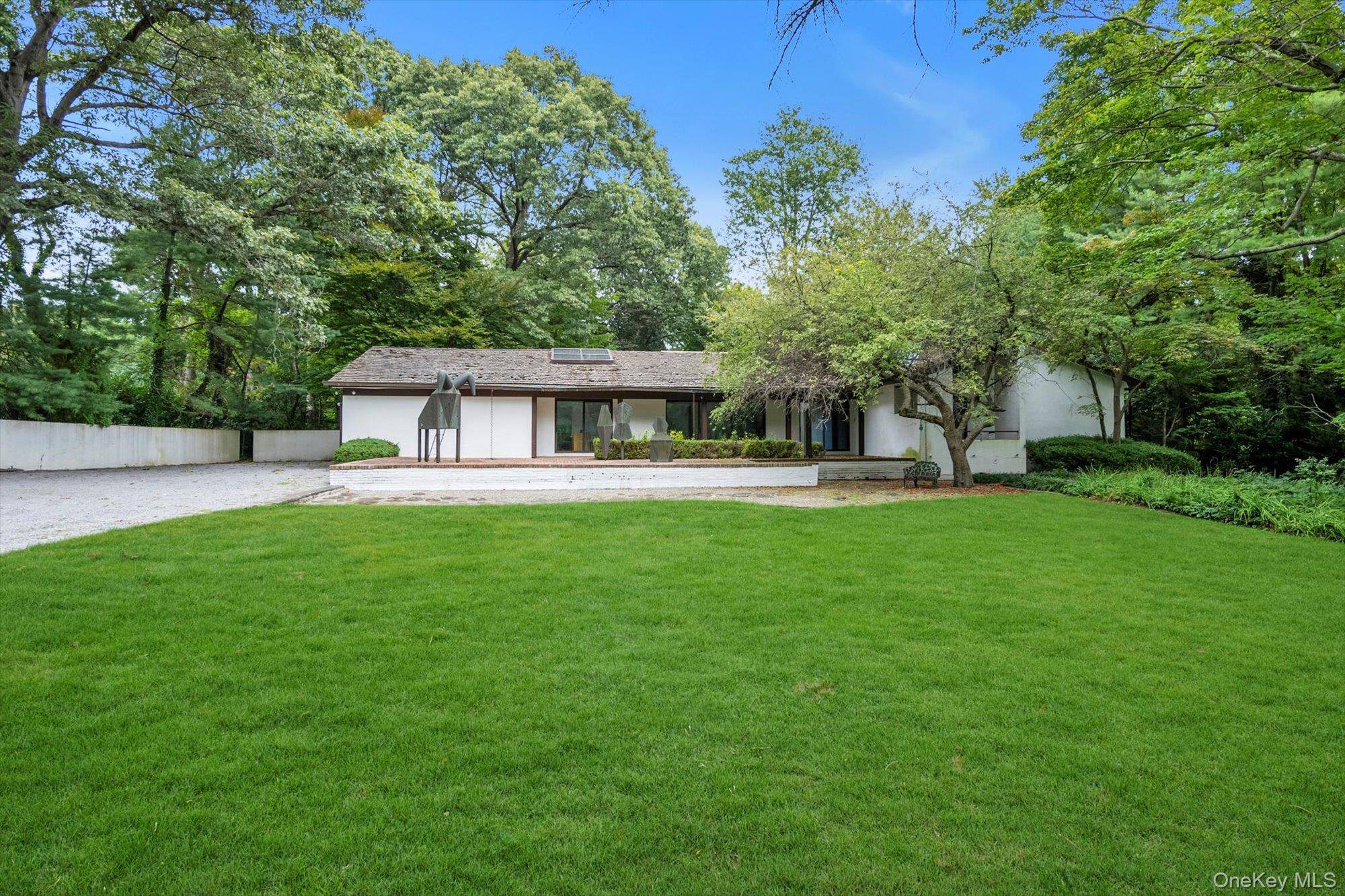 Sophisticated, private and park like, this Sands Point estate set on 3.