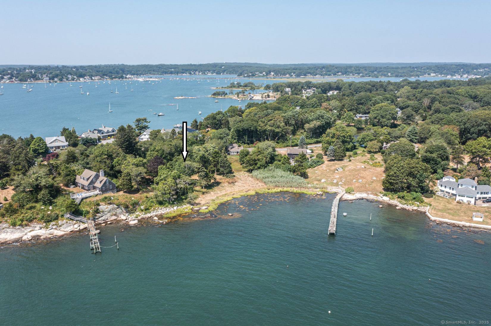 Direct Water Front with Unobstructed Water Views from this Charming Cozy Circa 1932 Two Story English Style Cottage.