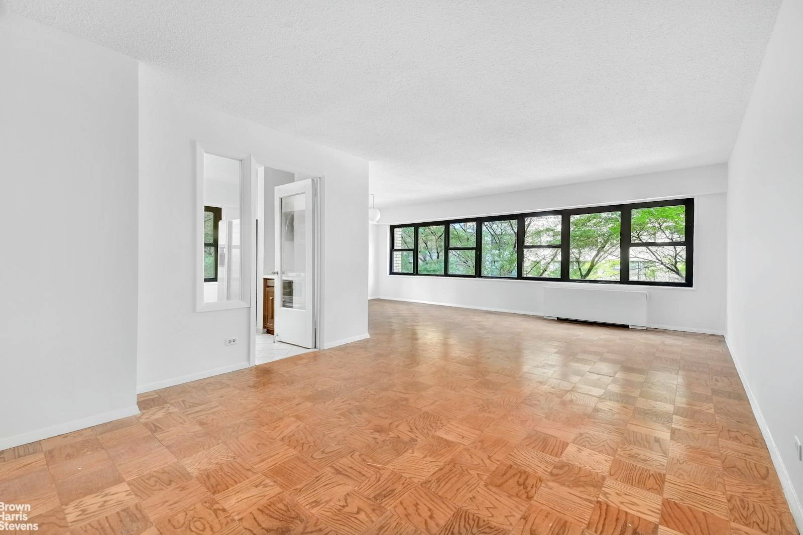 A wall of windows and tree top views are your first impression when you enter this NW corner one bedroom, one and a half bath residence with endless possibilities.