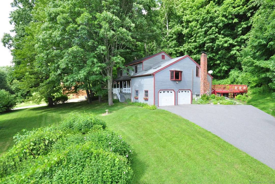 Spacious and open with high ceilings, this pool home is set on over 4 acres of quiet, wooded surroundings.