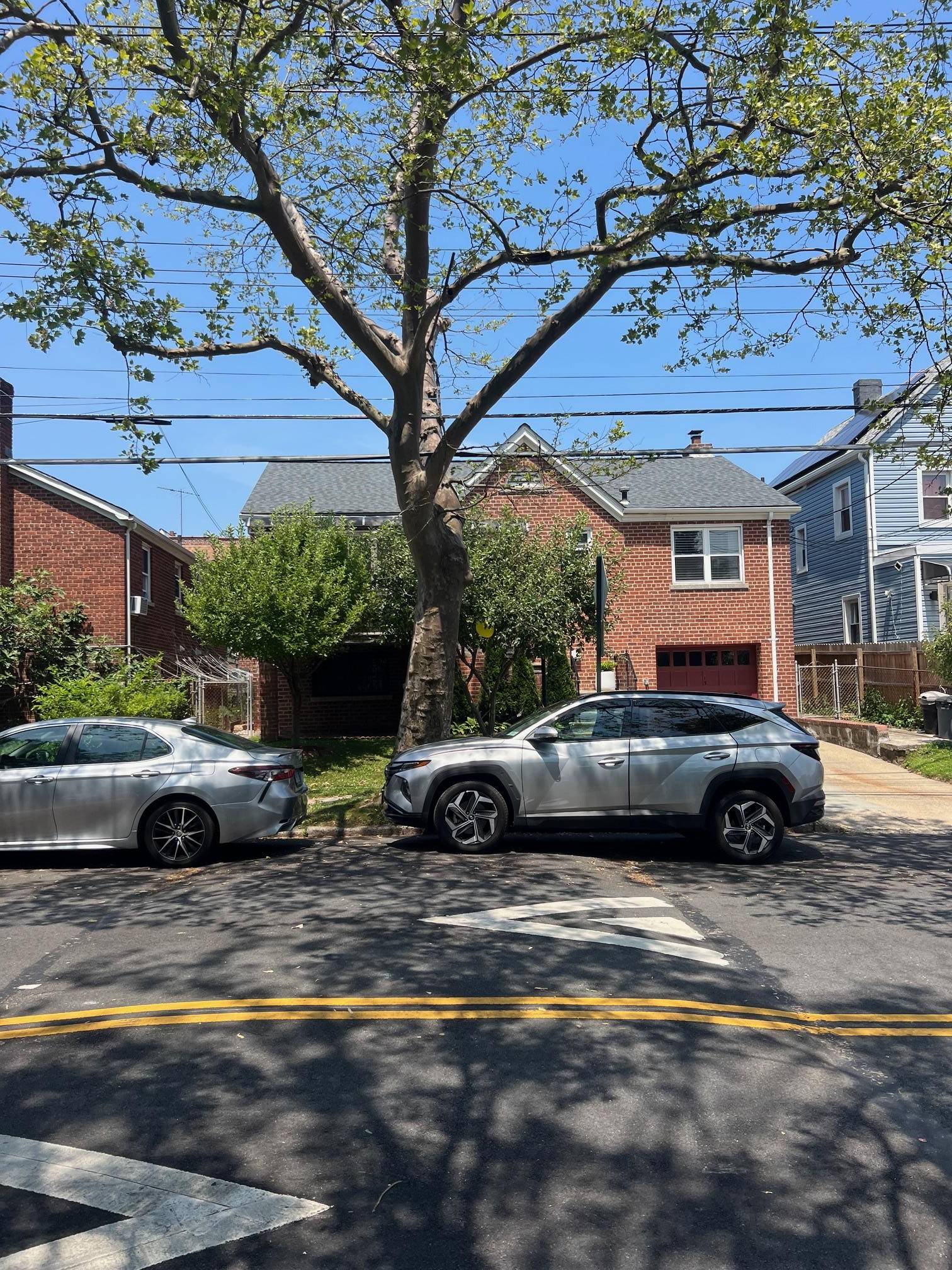 Brick detached house in Pelham garden section of The Bronx.