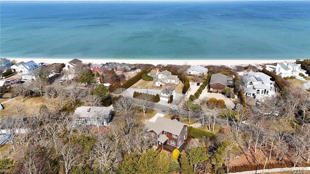 This house has it all. Private beach access to Great Peconic Bay, heated pool, central air, large custom kitchen, great room with fireplace, family room with slider to deck and ...