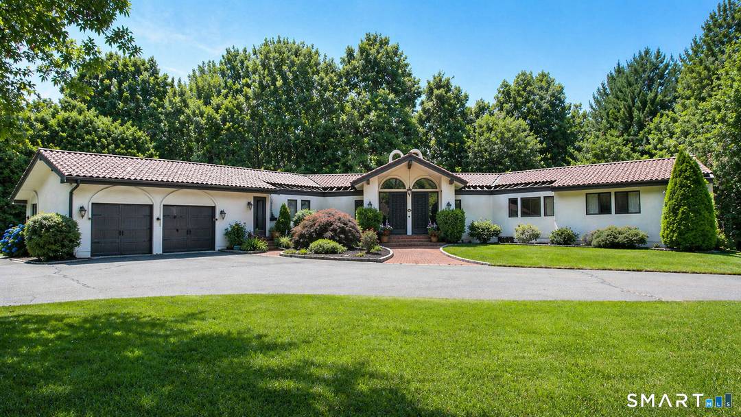 Tucked away on a highly sought after lane, a sweeping driveway entry to this distinctive custom built home.