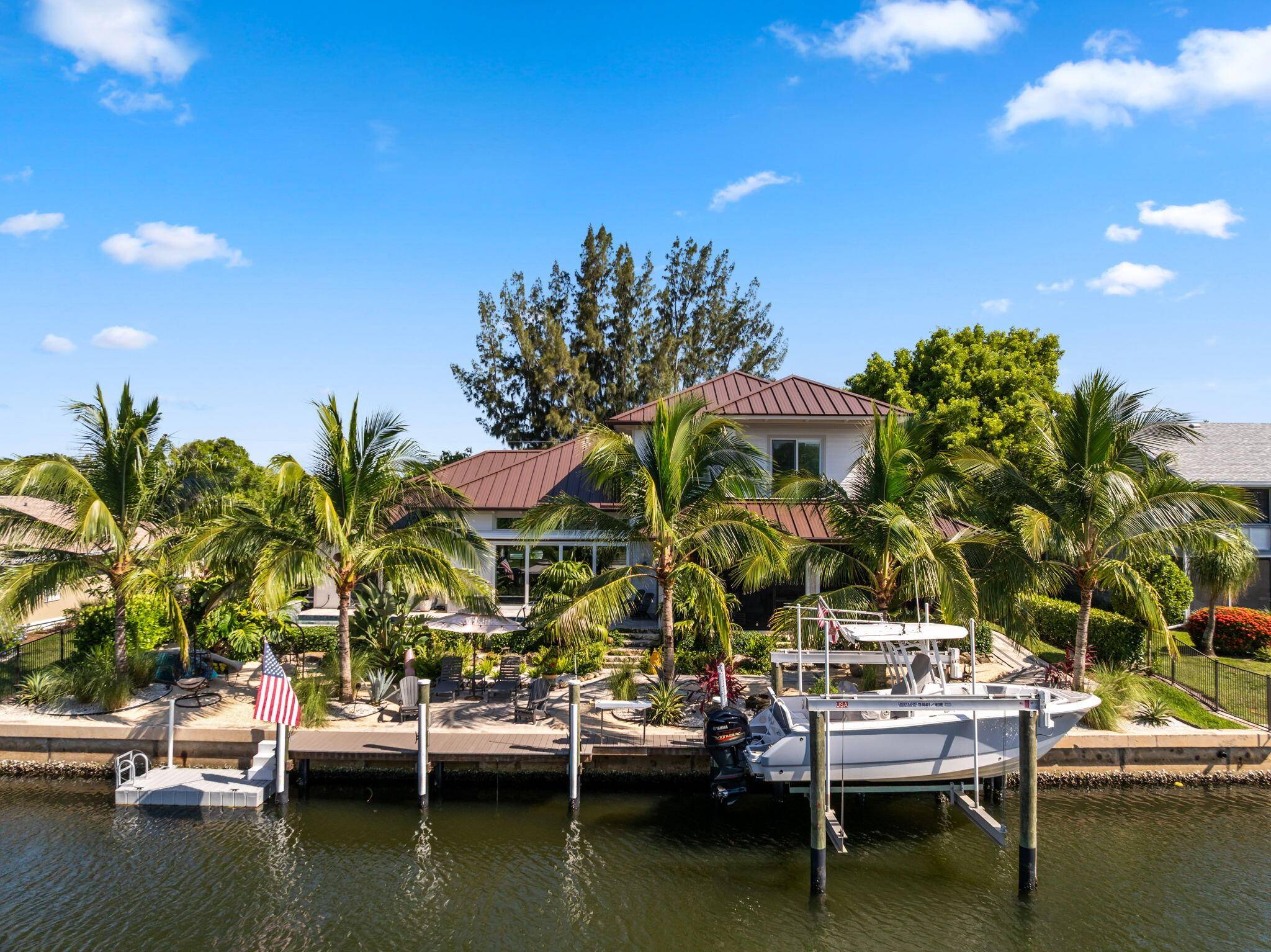 Stunning 2022 custom built waterfront estate with 100' of frontage in Hobe Sound, just minutes from Jupiter Island.