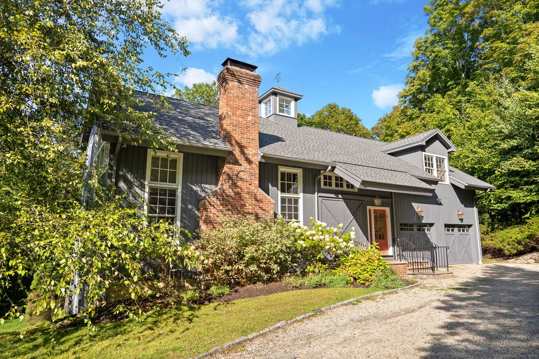 This stunning barn style contemporary home is tucked away on a quiet country road, less than a mile from Lake Waramaug.