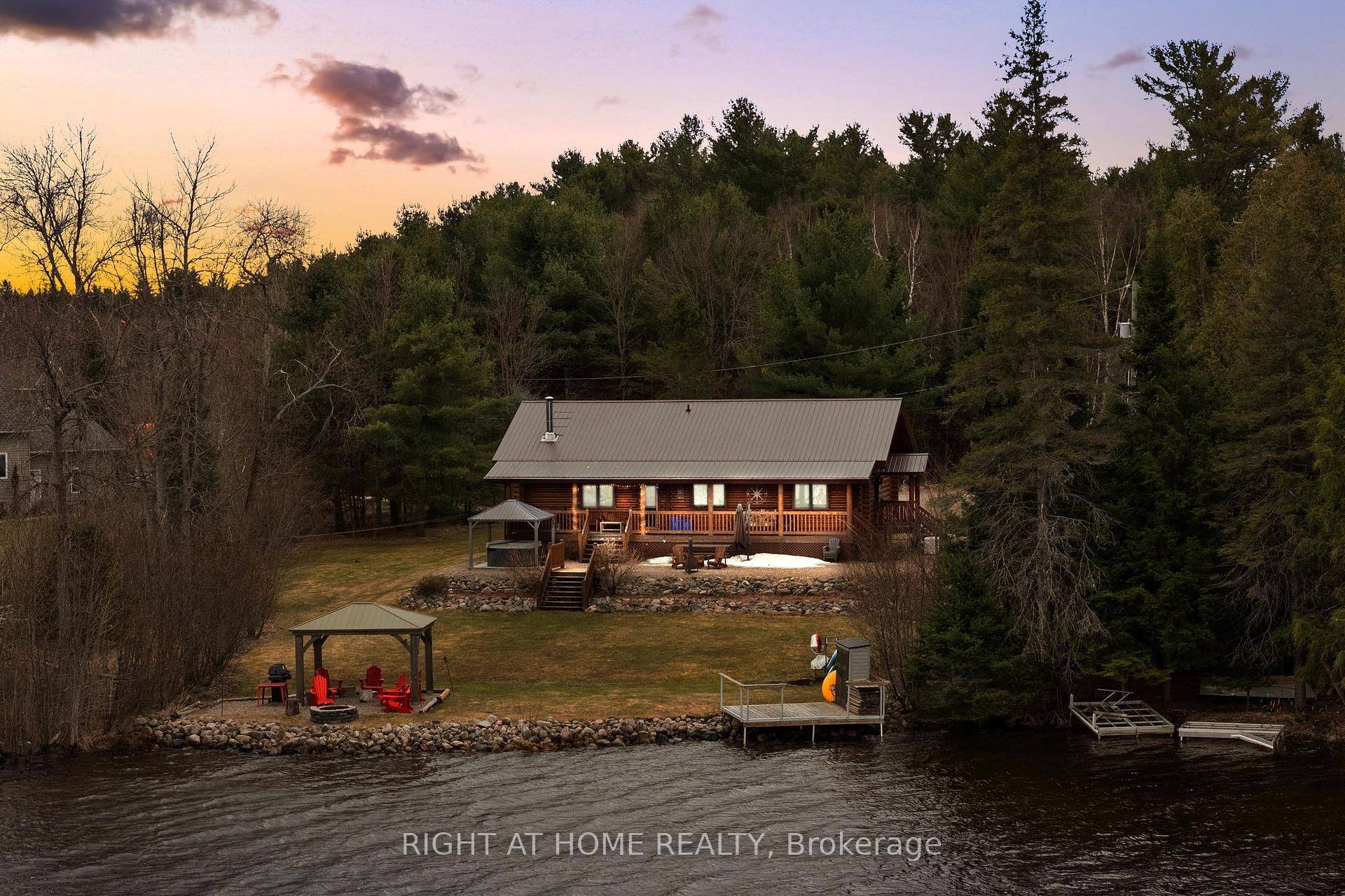Escape to your private paradise at 121 Muskie Lane, a stunning handcrafted log home on a serene 0.