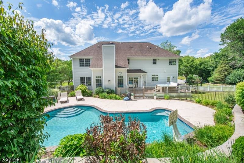 Experience luxury in this beautifully updated custom colonial, located on a private 0.