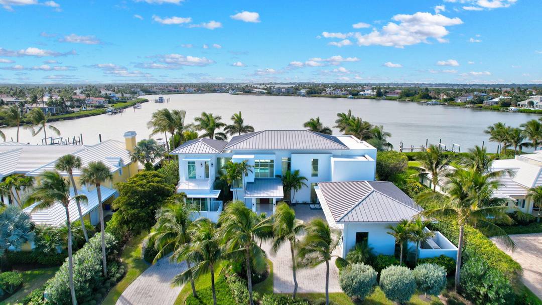 Experience the best of luxury living in this waterfront coastal contemporary estate in the prestigious community of Sailfish Point.