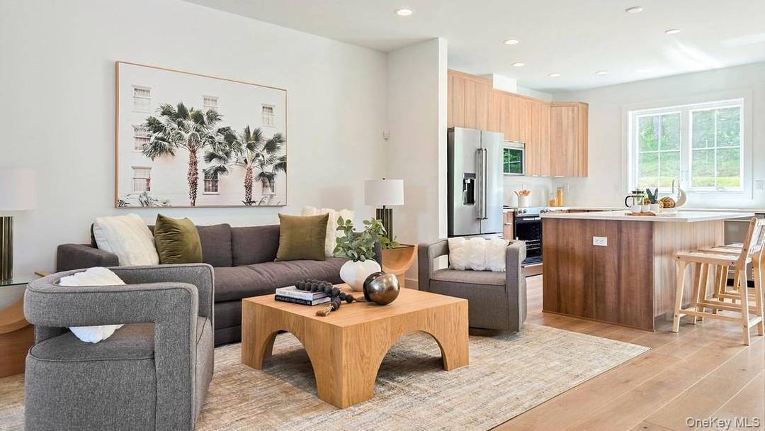 Summer 2026 Completion The Colgate's main living level offers views of the beautiful great room and dining room from its airy two story foyer.