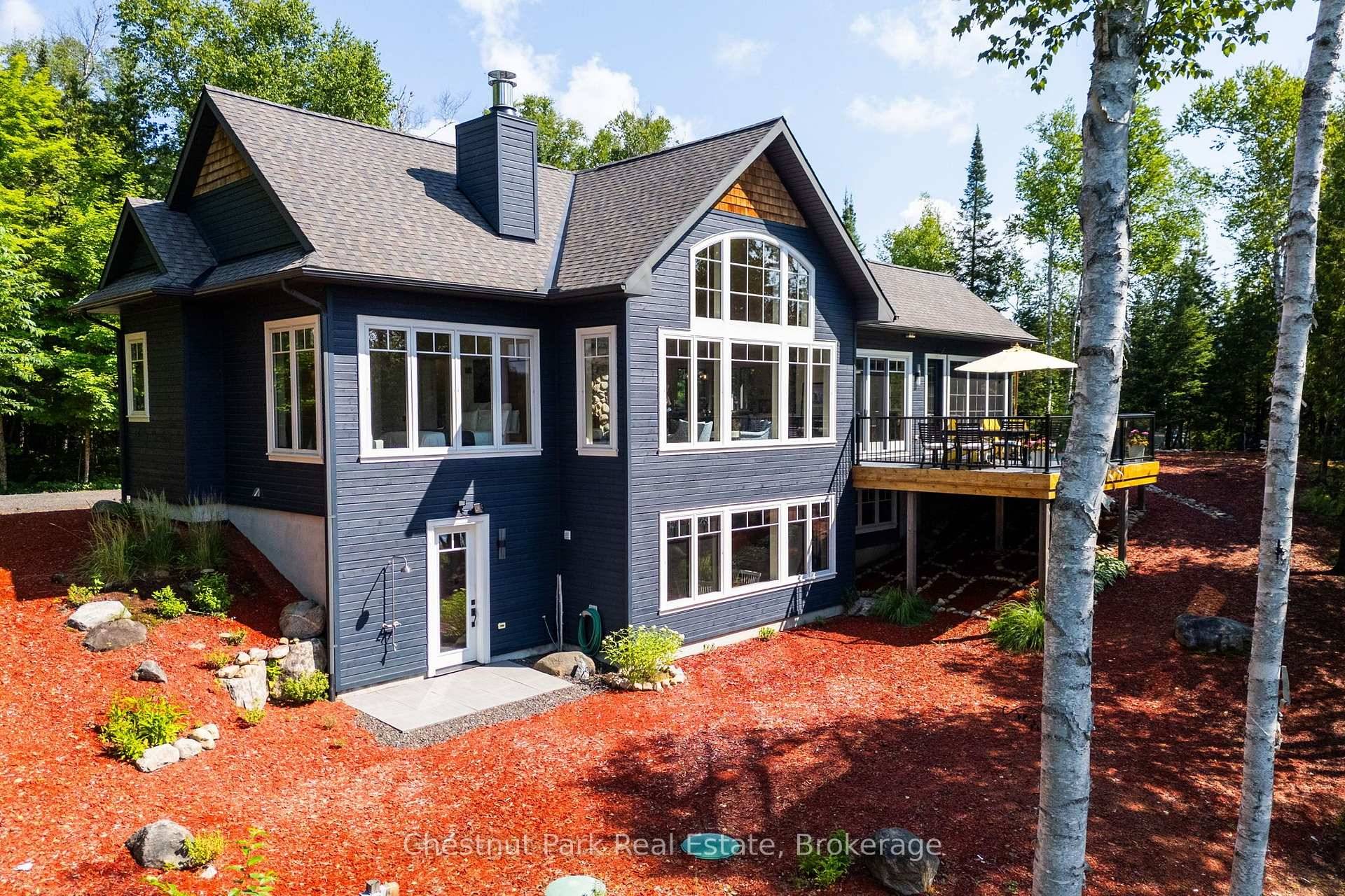 Turn key custom waterfront home on Oxtongue Lake with 958 of south facing shoreline and 10.