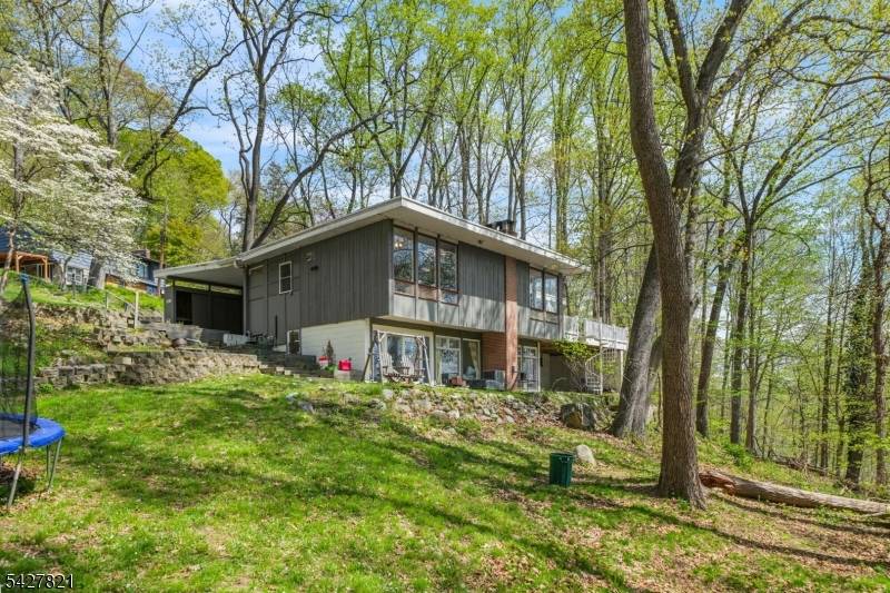 Private contemporary mid century modern home set on a serene 1.