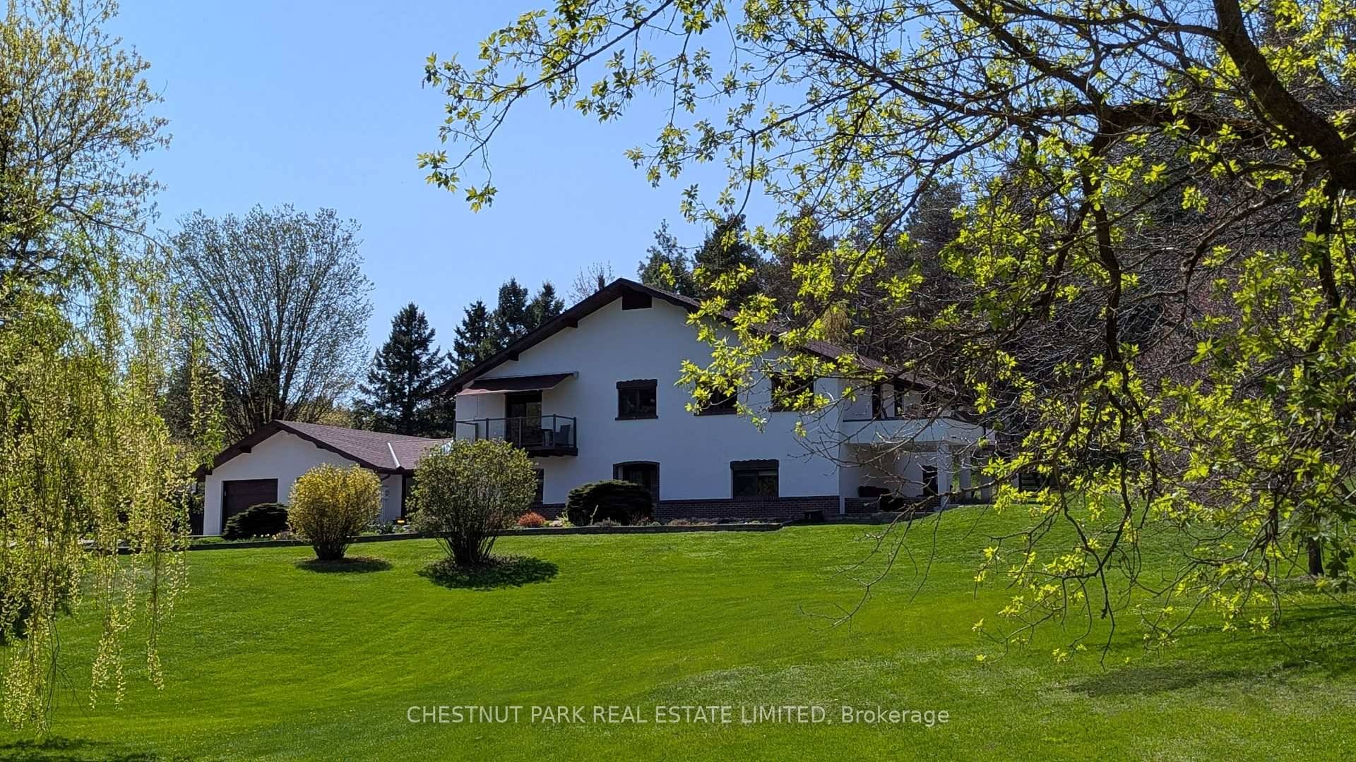 Tucked away on a quiet country lane, this meticulously crafted custom home sits on 5.
