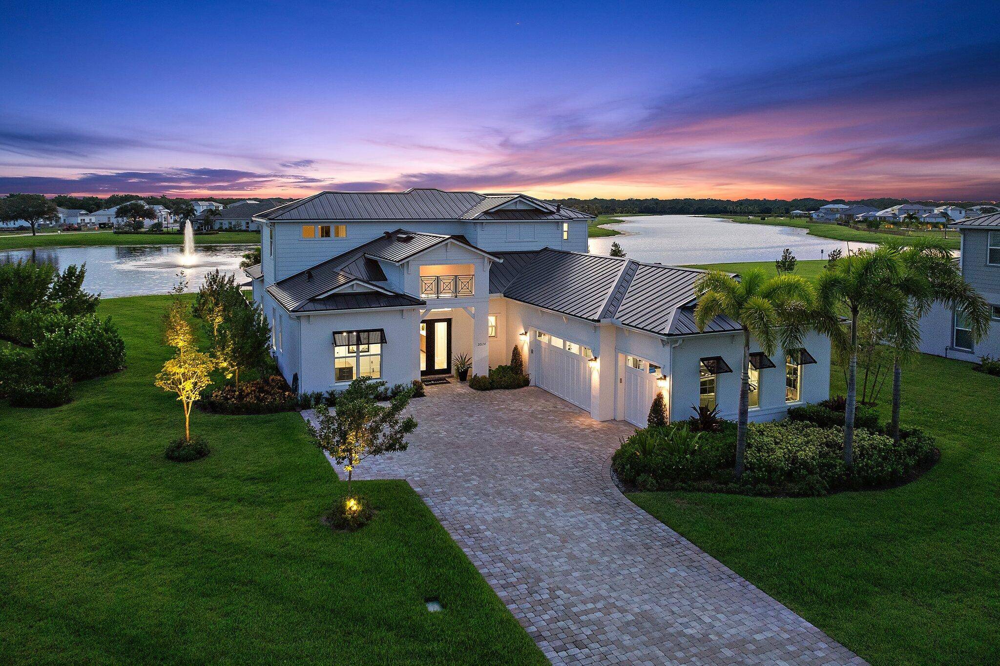 Enjoy wide water views across a large lake with fountain in Bridgewater, one of the hottest selling communities in Jupiter, Florida.