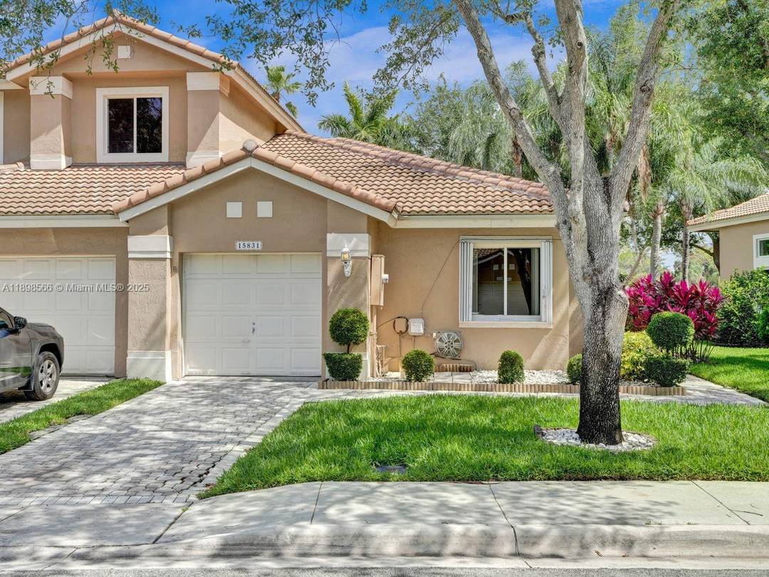 Charming ONE STORY CORNER UNIT nestled in the upscale Golf Community of Grand Palms.