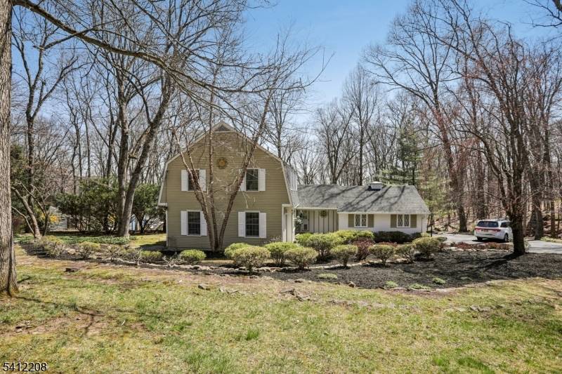 This Puddingstone Heights home offers sophisticated living on an open, wooded lot w private grounds.