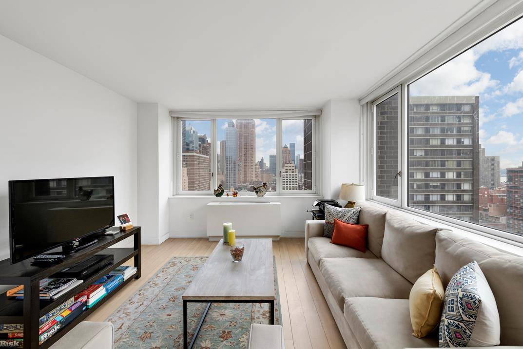 Step into this spacious corner two bedroom, two bath home that enjoys placid South Western light and epic sunsets over beautiful city vistas and partial hudson views encased in wall ...