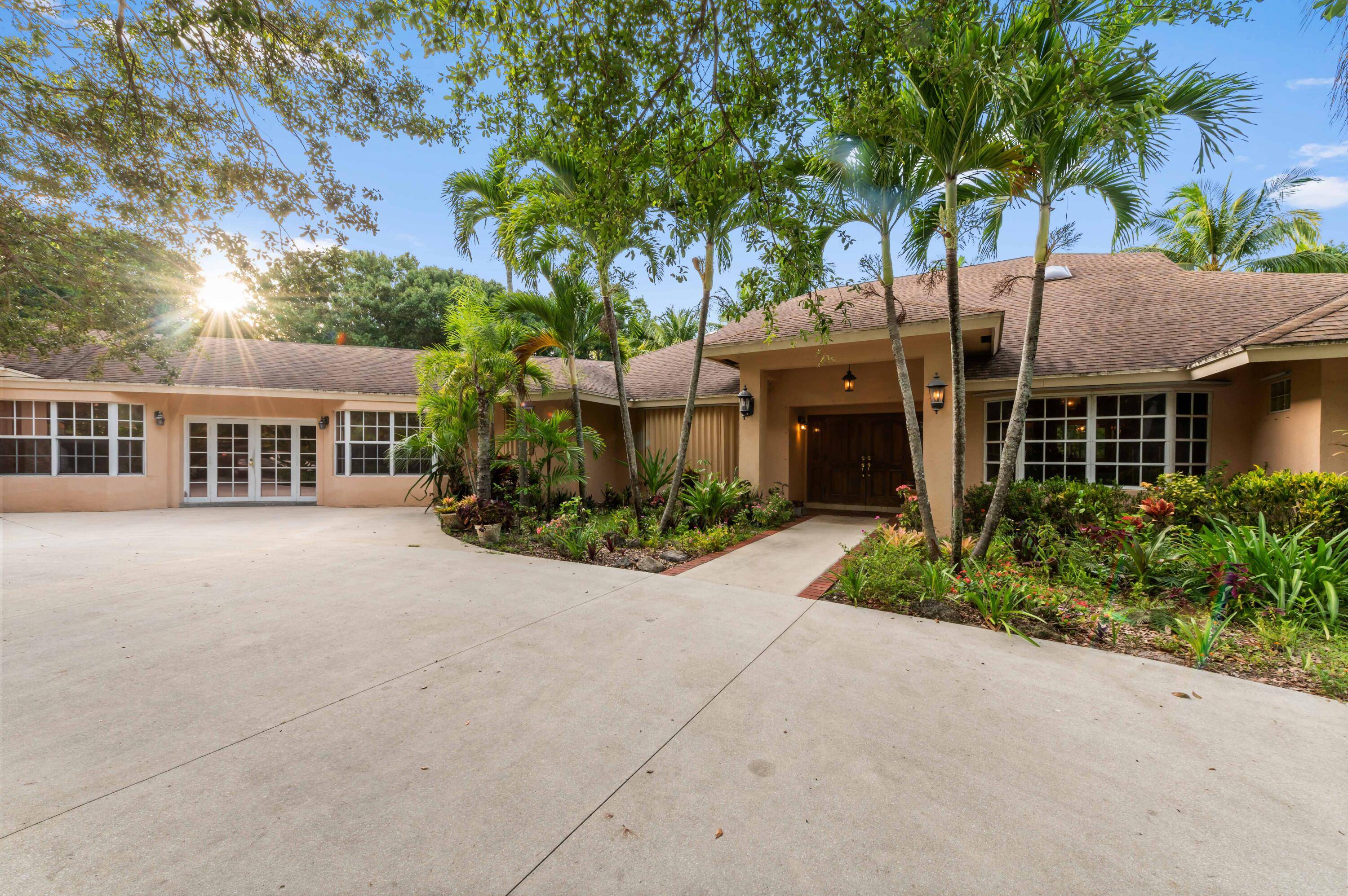 Experience the rare opportunity to own a one of a kind estate in Palm Beach Farms one of only two designated rural overlay areas in Palm Beach County.